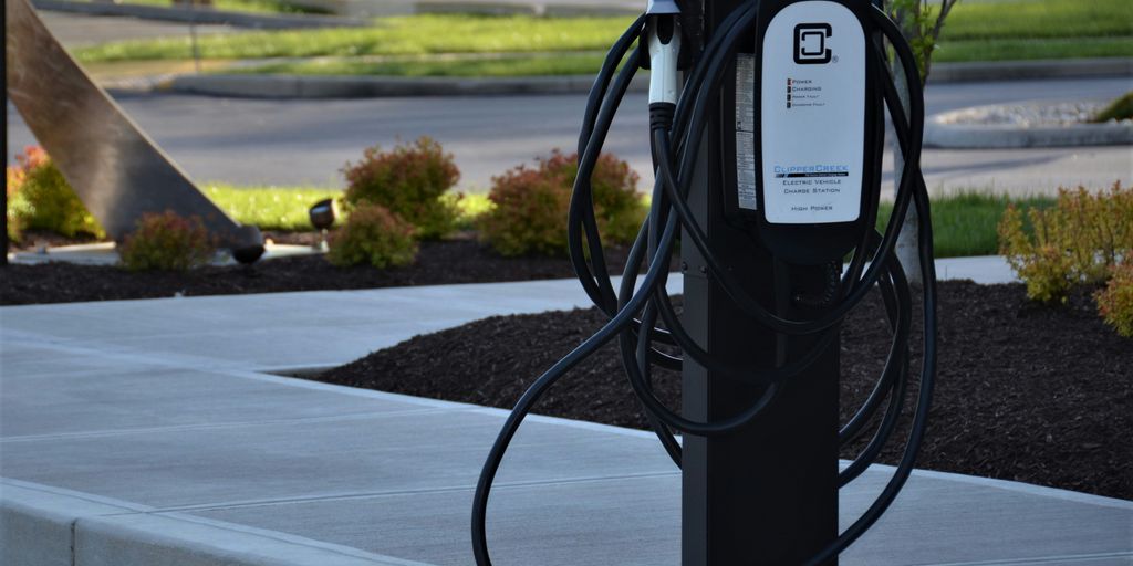 black metal stand on gray concrete road during daytime