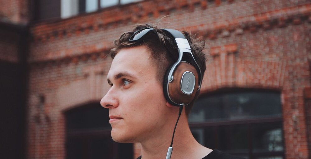 man using black and gray corded headphones