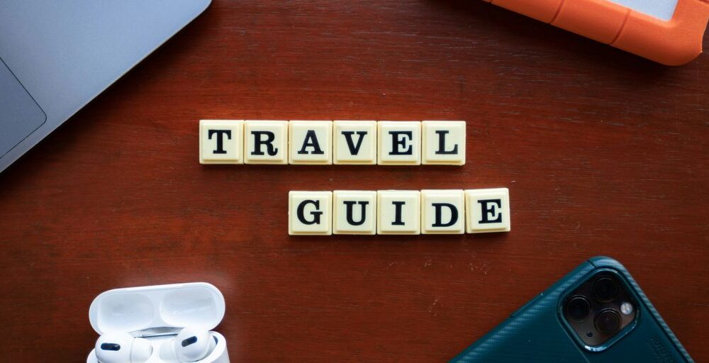 a wooden table topped with a cell phone and ear buds