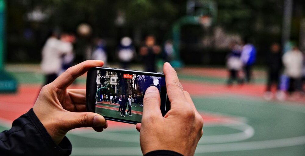 A person taking a picture of a basketball court