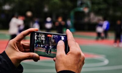 A person taking a picture of a basketball court