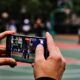 A person taking a picture of a basketball court