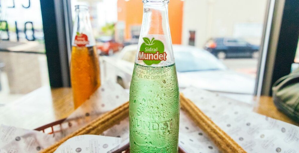 a close up of a bottle of soda on a table