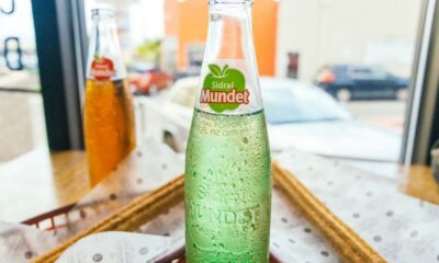 a close up of a bottle of soda on a table