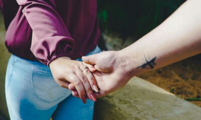 couple holding hands during daytime