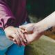 couple holding hands during daytime