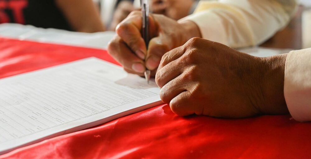 a person writing on a piece of paper