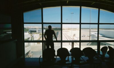 silhouette of man standing near glass window