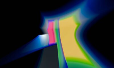 A blurry image of a black background with blue and yellow lines