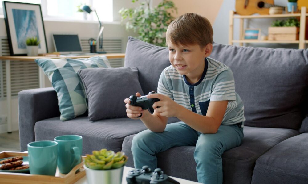 Boy playing video games on couch