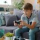 Boy playing video games on couch