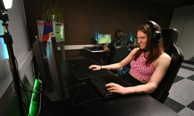 A woman sitting at a desk with headphones on