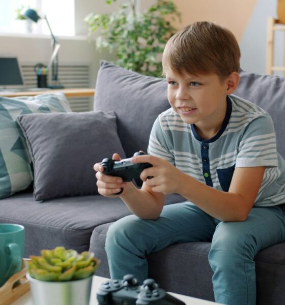 Boy playing video games on couch