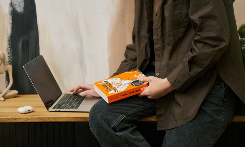 a person sitting on a table with a laptop