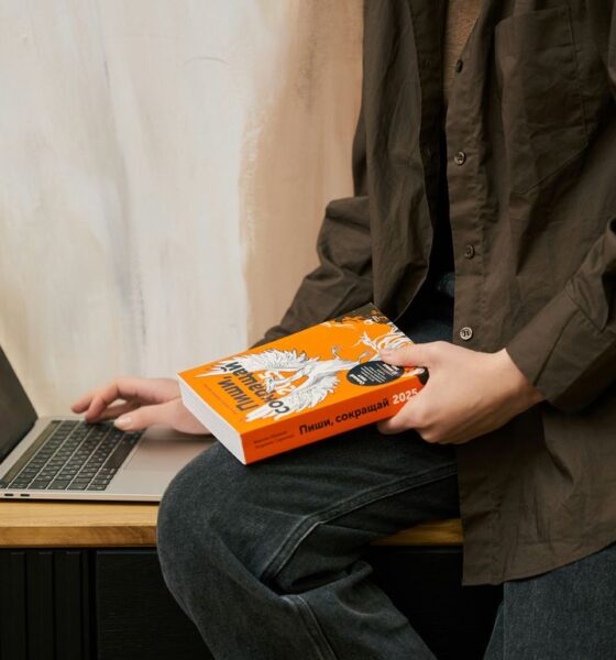 a person sitting on a table with a laptop