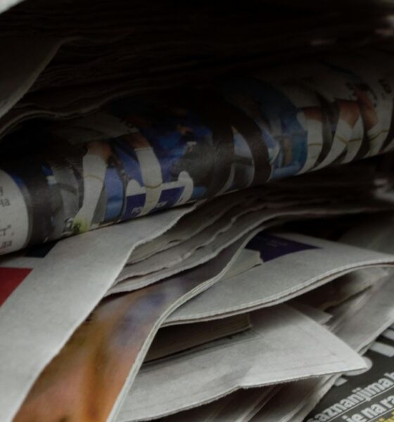 a bunch of newspapers stacked on top of each other