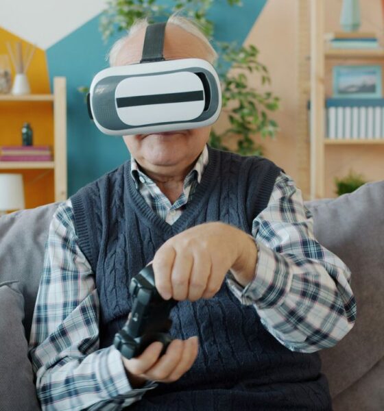 Elderly man wearing vr headset plays video game