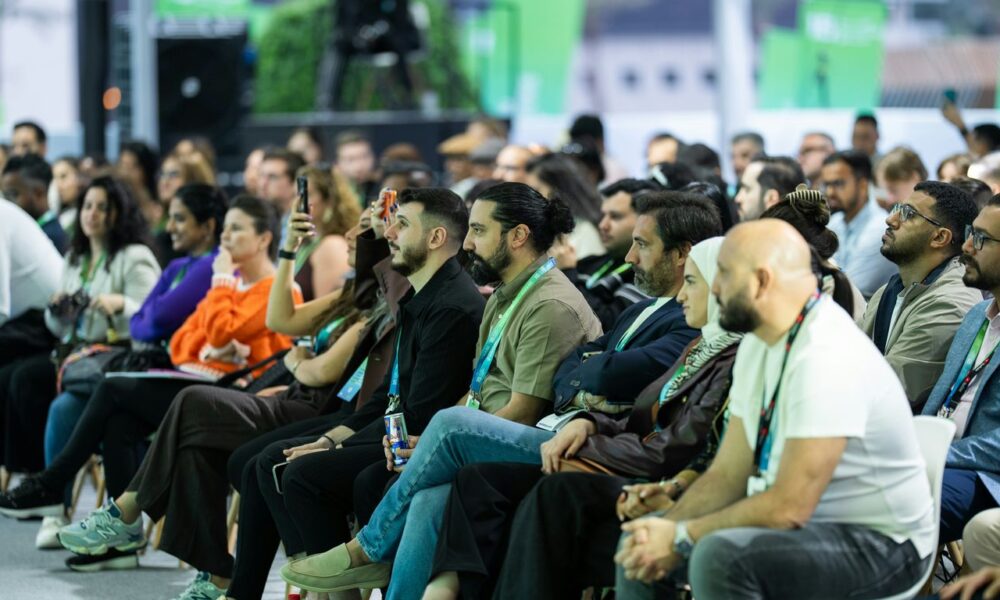 Diverse audience attentively listening at a conference event.
