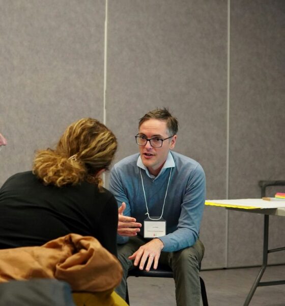 Three people talking in a casual meeting